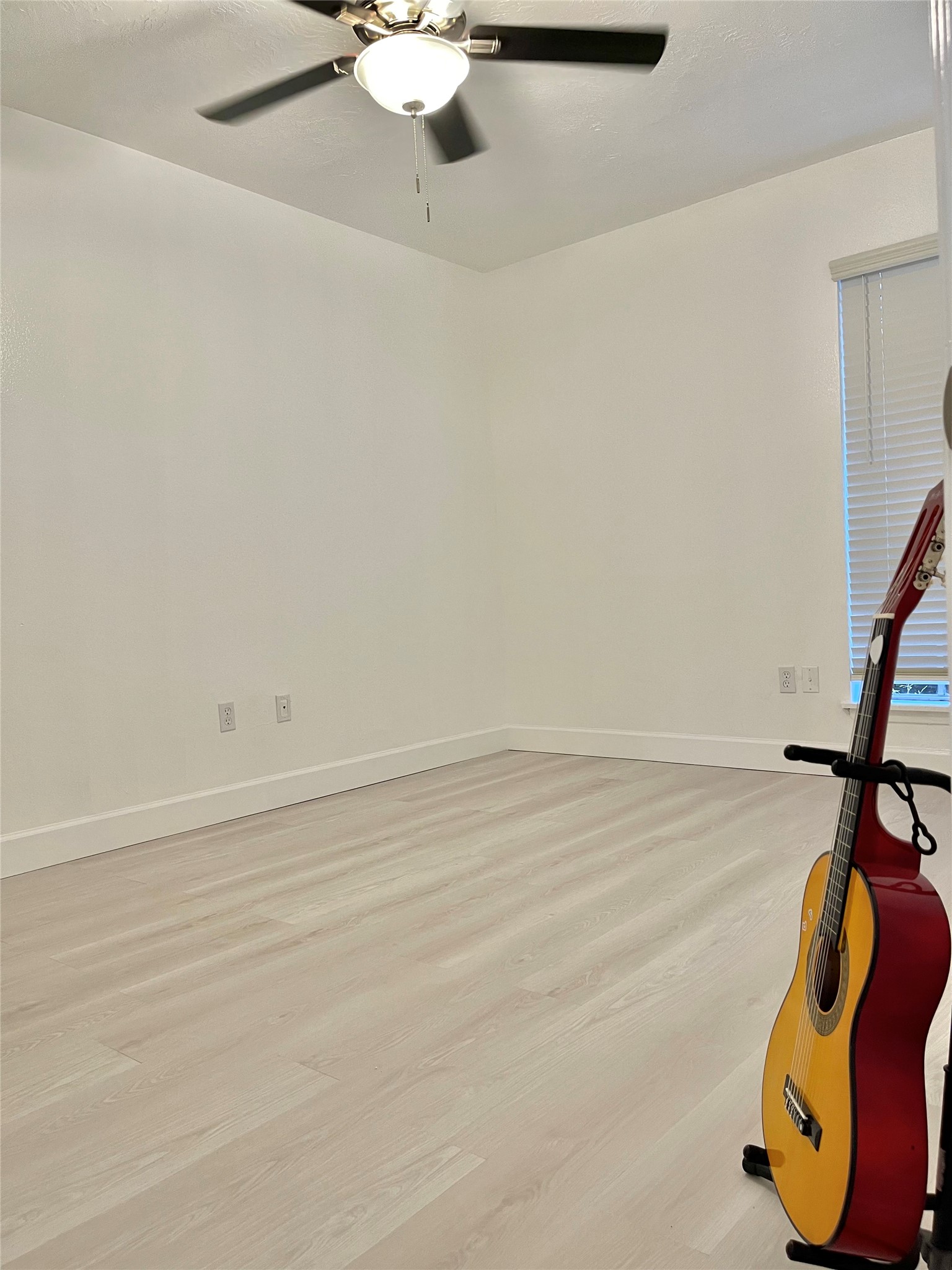 3400 Timmons Lane, Unit 13 Houston, TX 77027 - Photo 26 of 35 a view of a room with wooden floor and ceiling fan