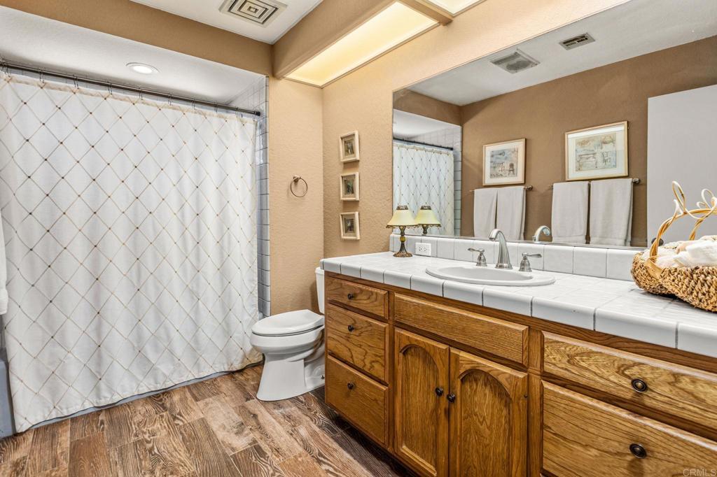 17901 Lyons Valley Road Jamul, CA 91935 - Photo 37 of 52 a bathroom with a double vanity sink toilet and a mirror