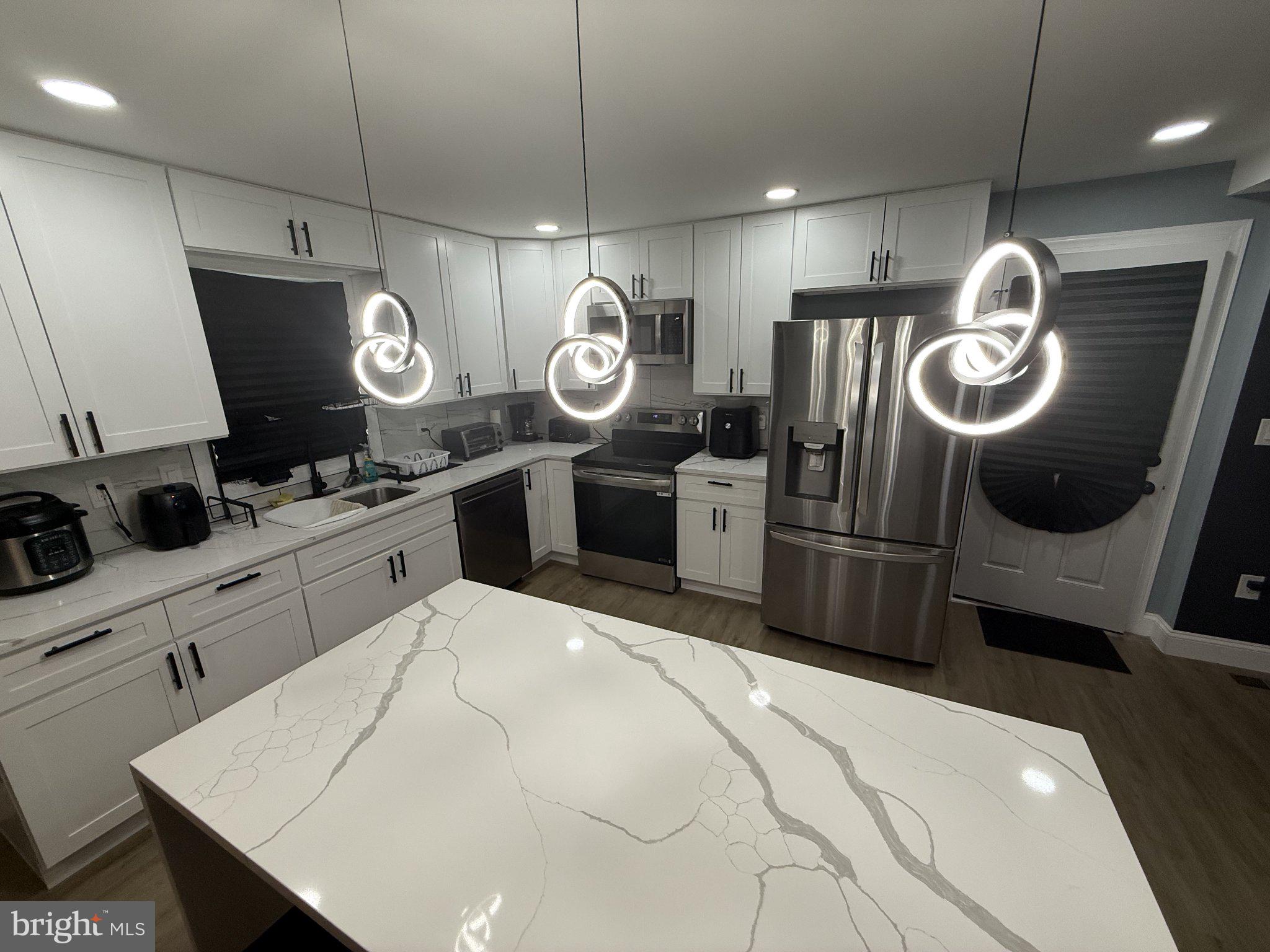 7022 Highbridge Road Bowie, MD 20720 - Photo 4 of 9 Sleek kitchen with modern lighting.