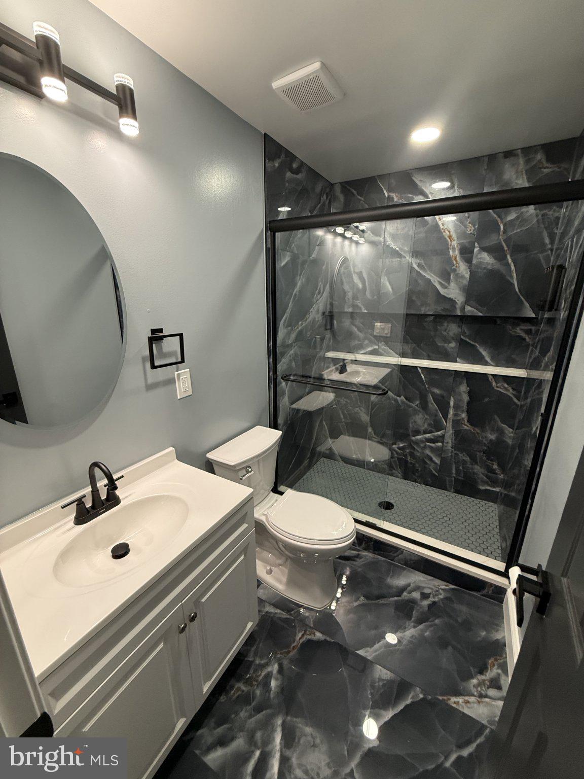 7022 Highbridge Road Bowie, MD 20720 - Photo 7 of 9 Sleek modern bathroom with elegant finishes.