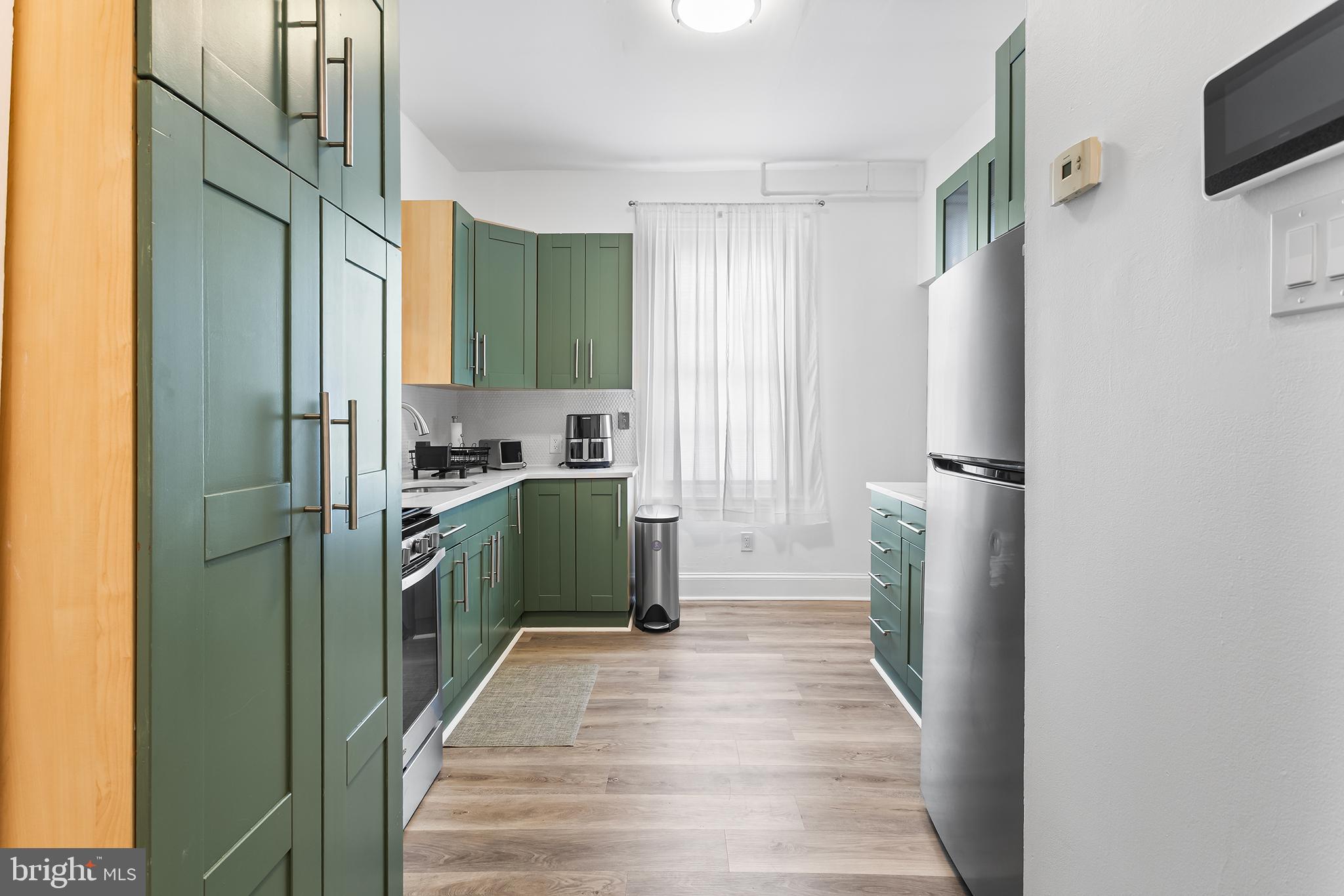 569 North 20th Street, Unit 2F Philadelphia, PA 19130 - Photo 11 of 21 a kitchen with stainless steel appliances granite countertop a refrigerator and a sink