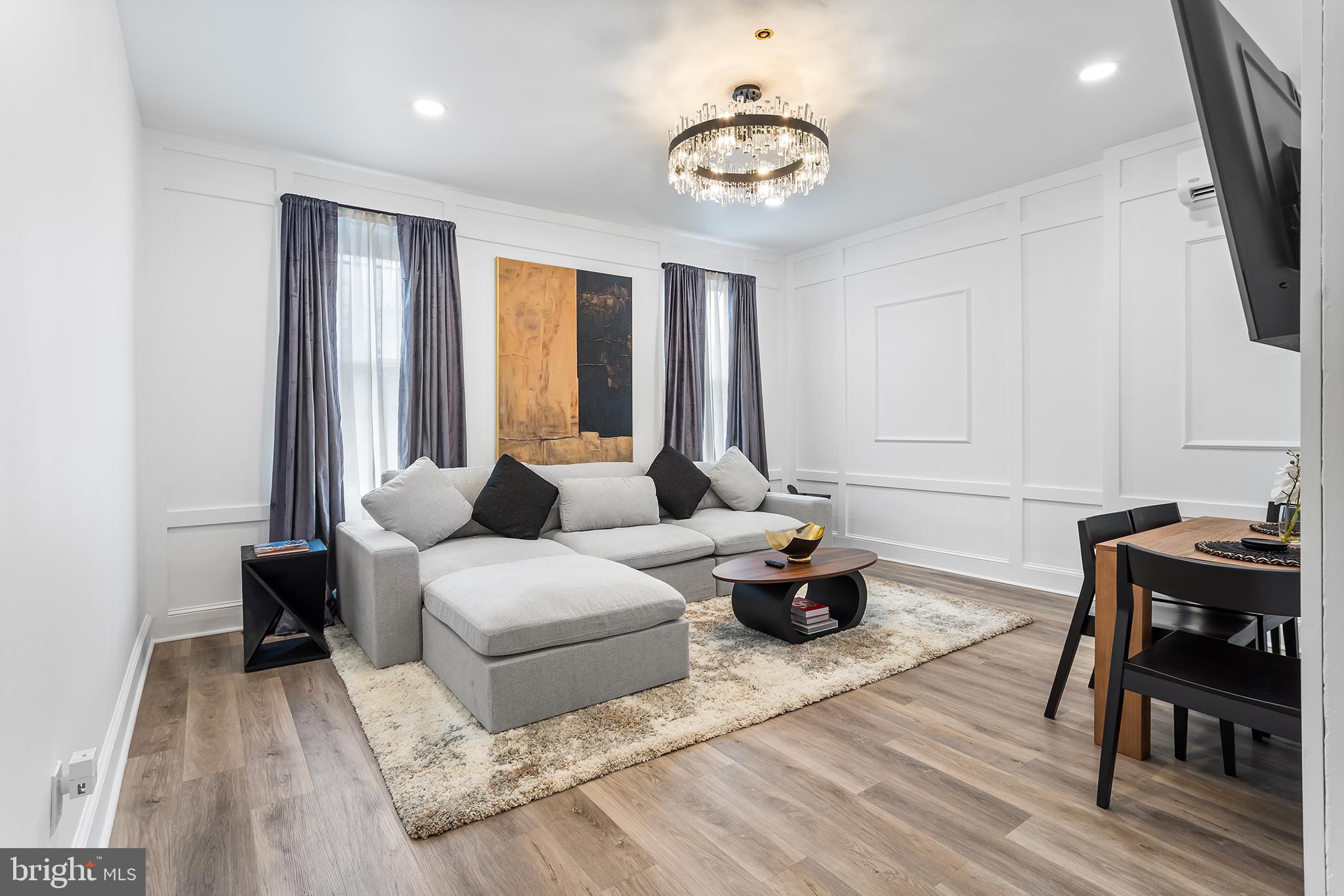 569 North 20th Street, Unit 2F Philadelphia, PA 19130 - Photo 5 of 21 a living room with furniture and wooden floor