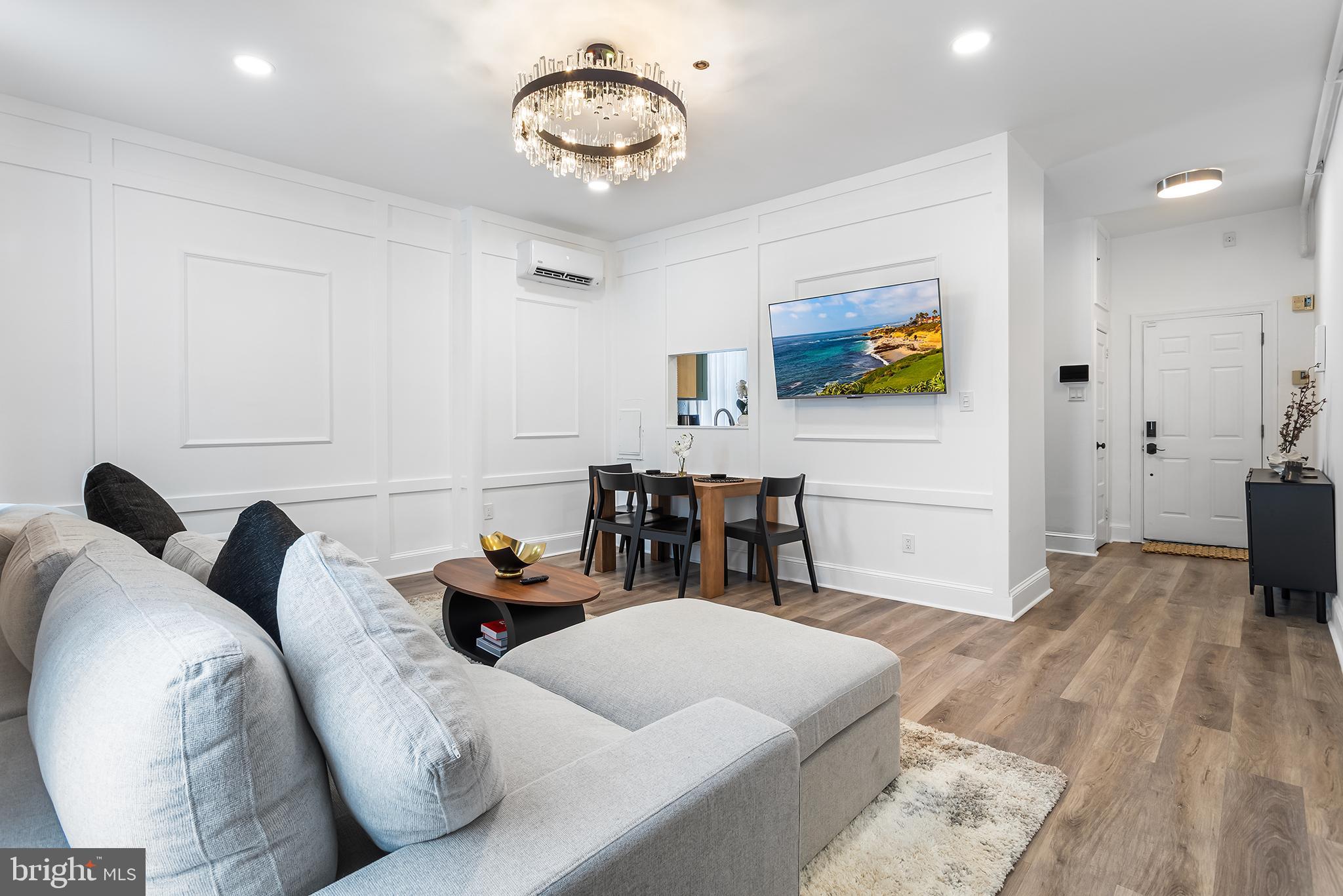 569 North 20th Street, Unit 2F Philadelphia, PA 19130 - Photo 6 of 21 a living room with furniture and a flat screen tv