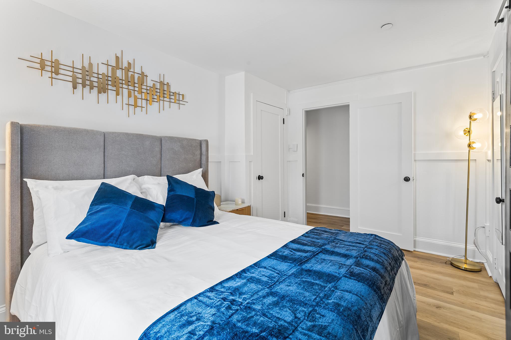 569 North 20th Street, Unit 2F Philadelphia, PA 19130 - Photo 7 of 21 a bedroom with a large bed and a chandelier