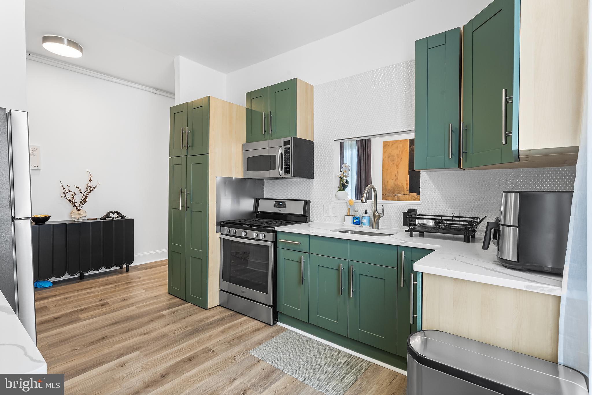 569 North 20th Street, Unit 2F Philadelphia, PA 19130 - Photo 10 of 21 a kitchen with a sink stove and refrigerator