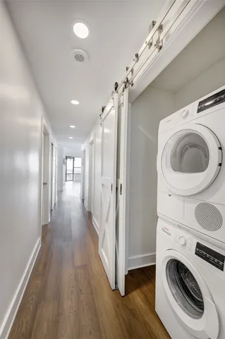 a view of a hallway with washer and dryer