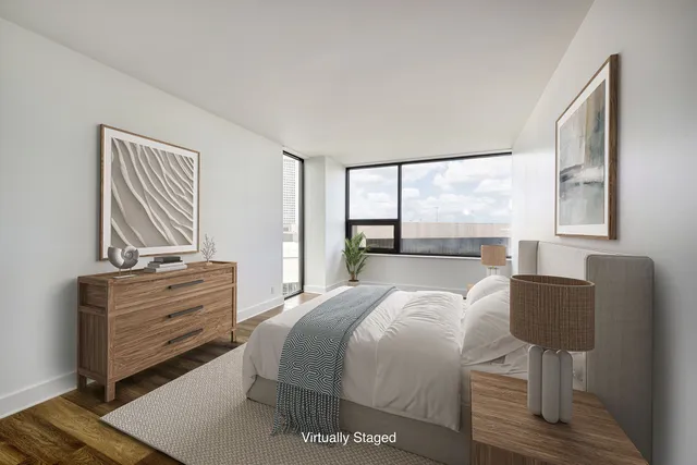 a bedroom with a bed and two windows