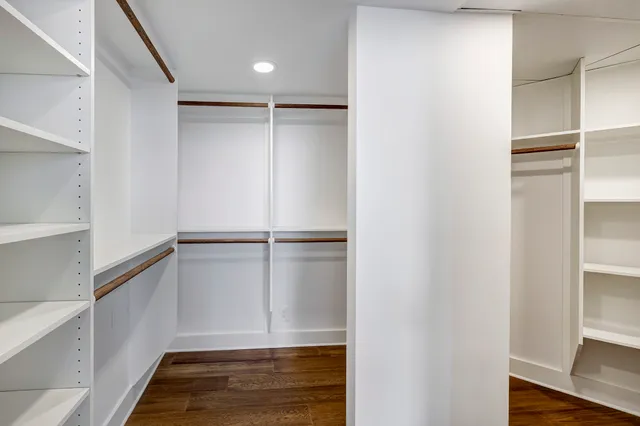 a view of walk in closet with empty racks