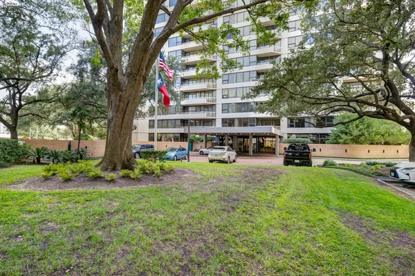 a tall building with trees in front of it