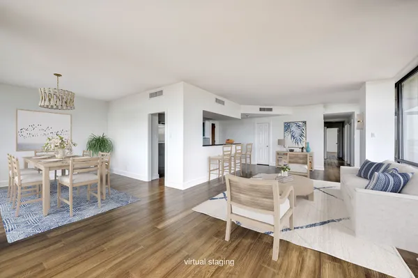 a living room with furniture a dining table and a potted plant