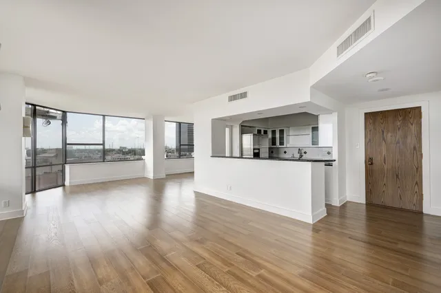a view of a living room hardwood floor and a window