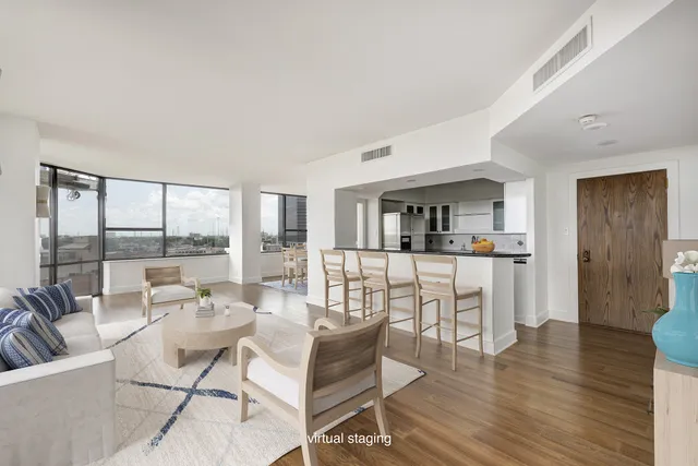 a living room with fireplace furniture and a wooden floor