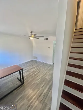a view of a room with wooden floor and stairs