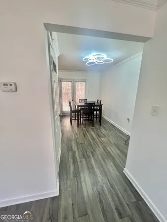 a view of a dining room with furniture and a chandelier