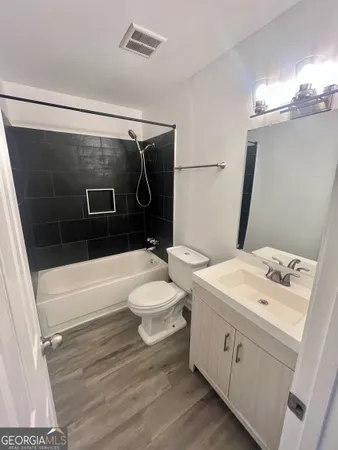a bathroom with a toilet a sink and a shower