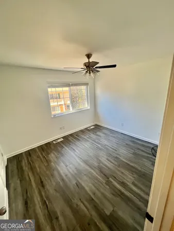 a view of a room with wooden floor and a window