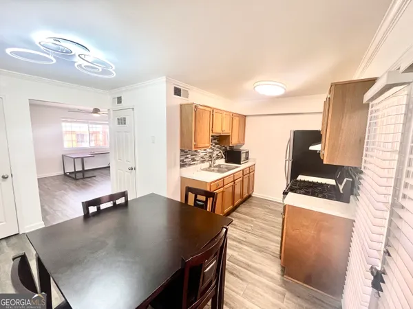 a living room with stainless steel appliances kitchen island granite countertop furniture and a kitchen view