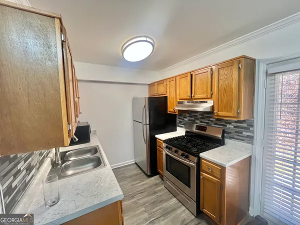 a kitchen with granite countertop a stove and a sink