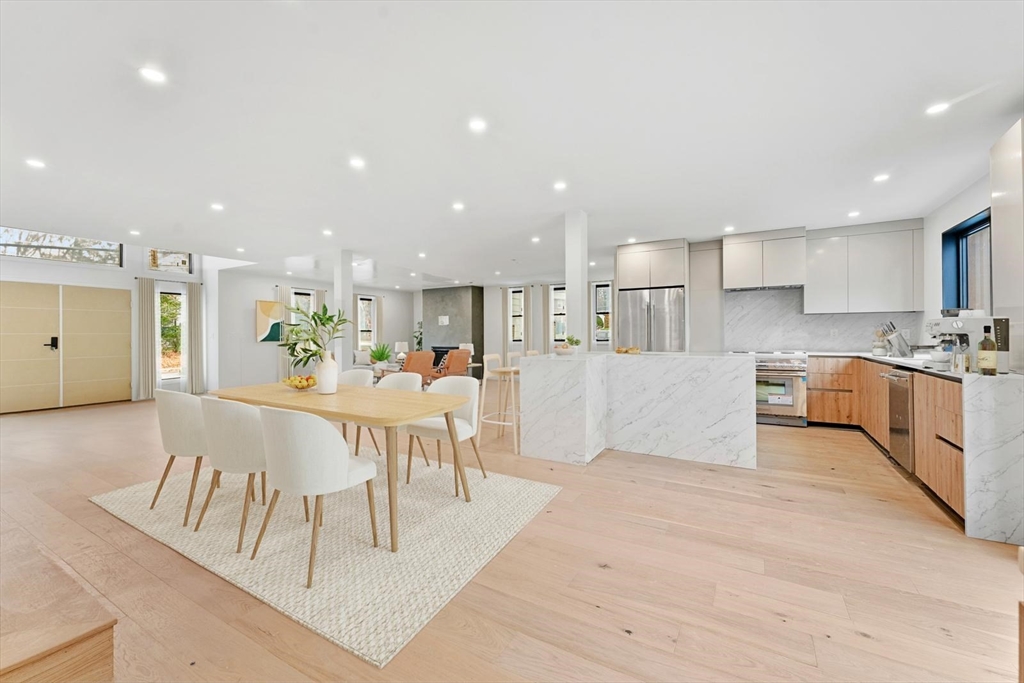 212 Central Avenue Needham, MA 02494 - Photo 16 of 29 a view of a kitchen with kitchen island white cabinets and stainless steel appliances