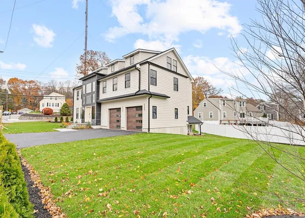 a view of a house with a big yard and large trees