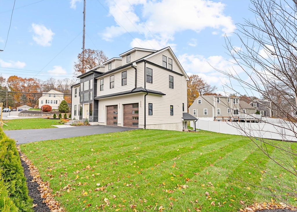 212 Central Avenue Needham, MA 02494 - Photo 2 of 29 a view of a house with a big yard and large trees