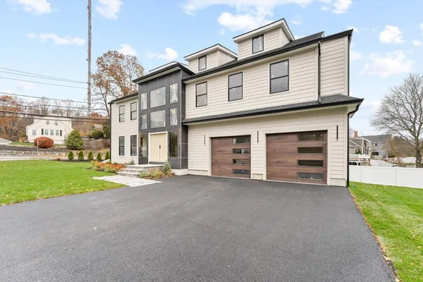 a view of a house with a yard and garage