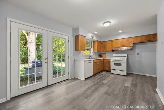 a kitchen with stainless steel appliances granite countertop a stove a sink and a microwave