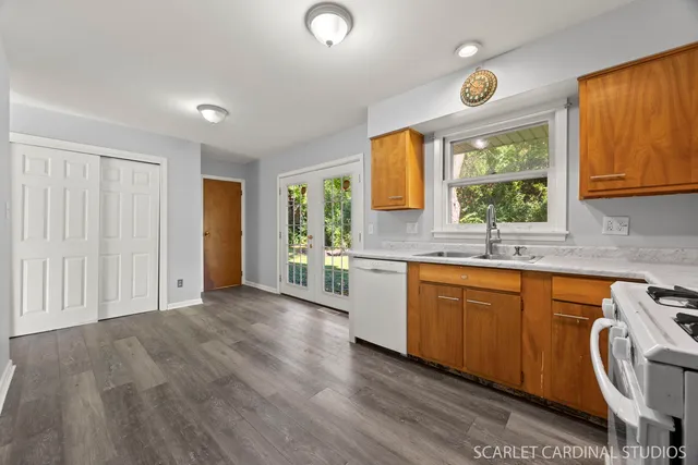 a view of a kitchen with wooden floor and a sink