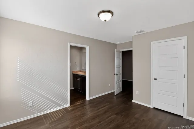 an empty room with wooden floor and closet