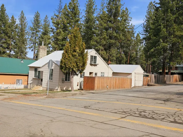 a front view of a house with a trees