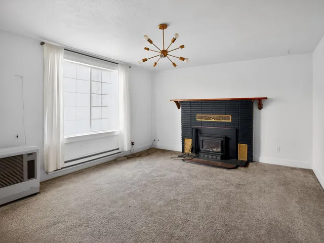 a view of an empty room with a fireplace