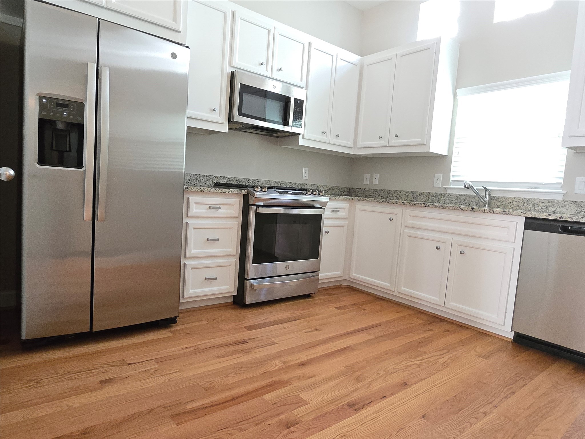 8705 Bryam Street, Unit 1701 Houston, TX 77061 - Photo 14 of 22 a kitchen with stainless steel appliances granite countertop a refrigerator and a stove top oven