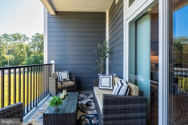 a view of a workspace with furniture and wooden floor