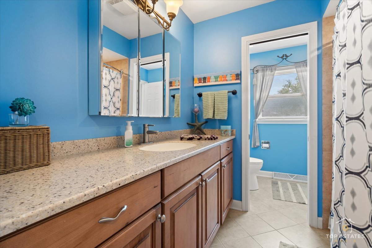 120-3 Three Oaks Road Cary, IL 60013 - Photo 16 of 28 a bathroom with a granite countertop sink and a mirror