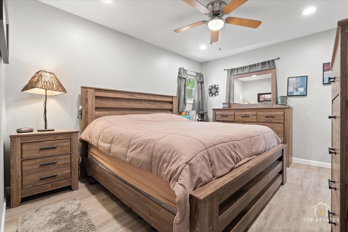 120-3 Three Oaks Road Cary, IL 60013 - Photo 17 of 28 a bed room with a bed and a ceiling fan