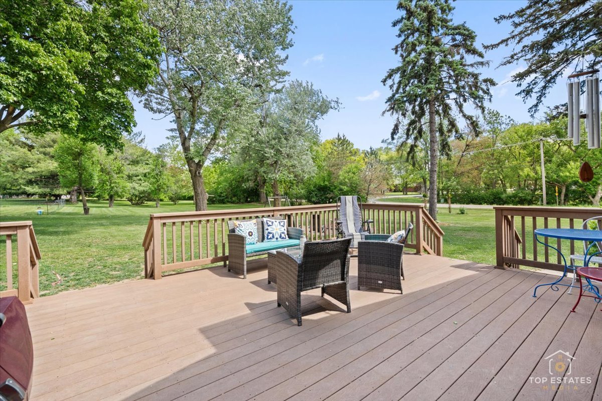 120-3 Three Oaks Road Cary, IL 60013 - Photo 25 of 28 a view of a deck with two chair and wooden floor