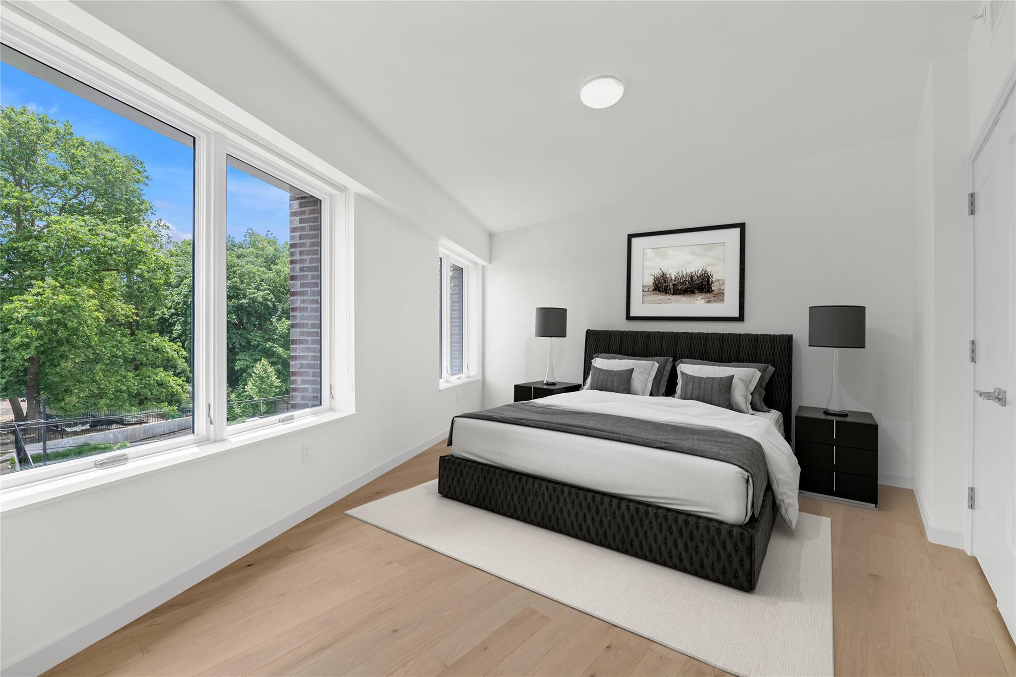218 Middle Neck Road, Unit 203 Great Neck, NY 11021 - Photo 15 of 29 Bedroom featuring vaulted ceiling and light wood-style floors