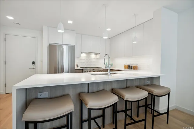 a kitchen with a table chairs refrigerator and cabinets