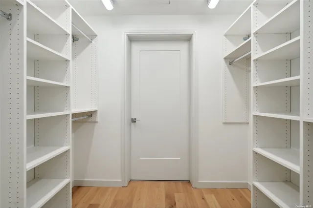 a view of walk in closet with empty racks