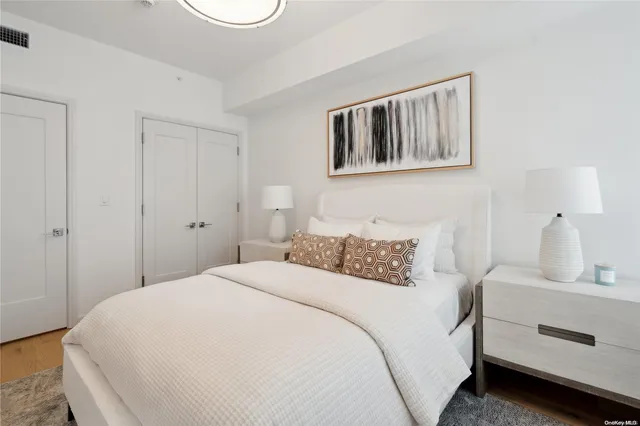 a bedroom with a white bed and a chandelier