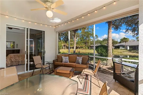 a view of a tennis ground with large trees