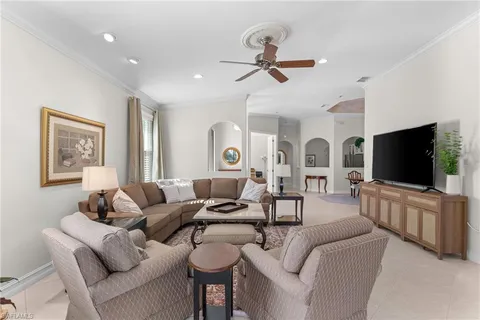 a dining room with furniture and a chandelier