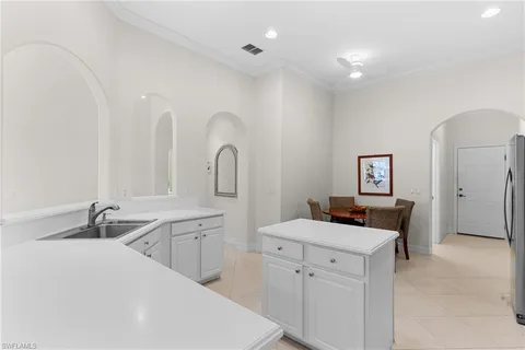 a bedroom with a bed a dresser next to a window