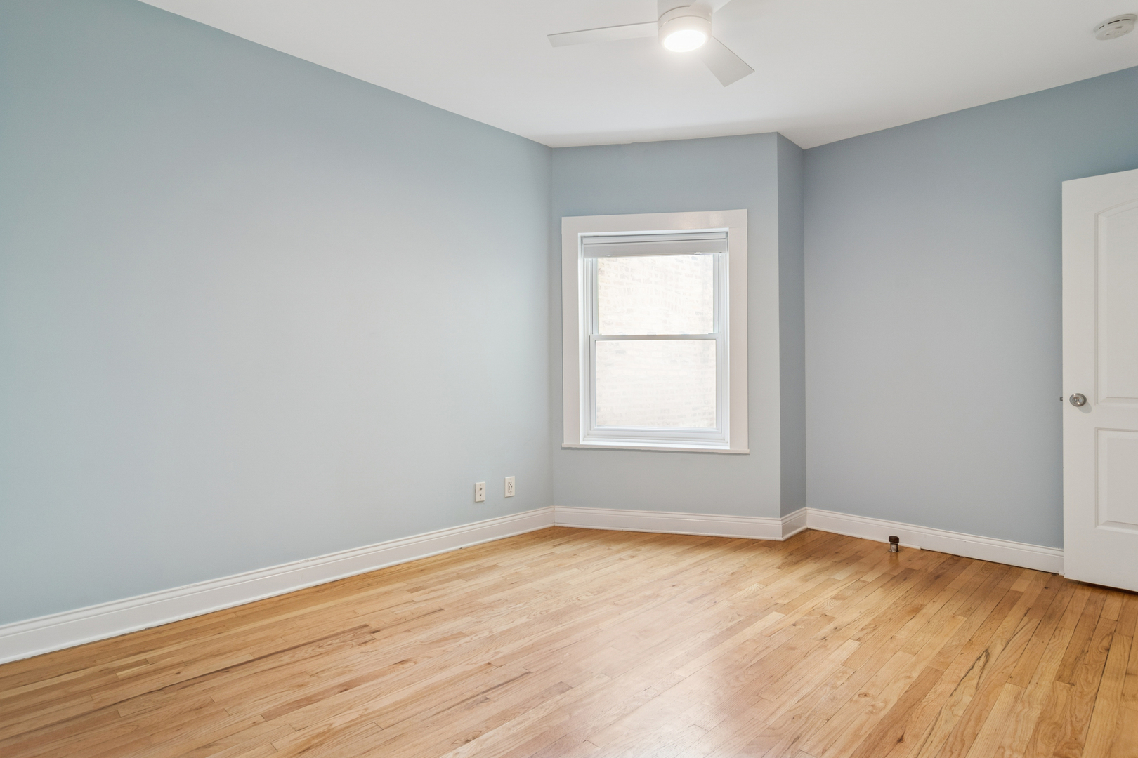6232 North Broadway, Unit 2 Chicago, IL 60660 - Photo 21 of 23 an empty room with wooden floor and windows