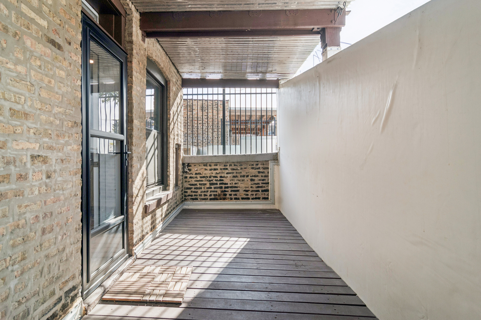 6232 North Broadway, Unit 2 Chicago, IL 60660 - Photo 23 of 23 a view of a porch with wooden floor and fence