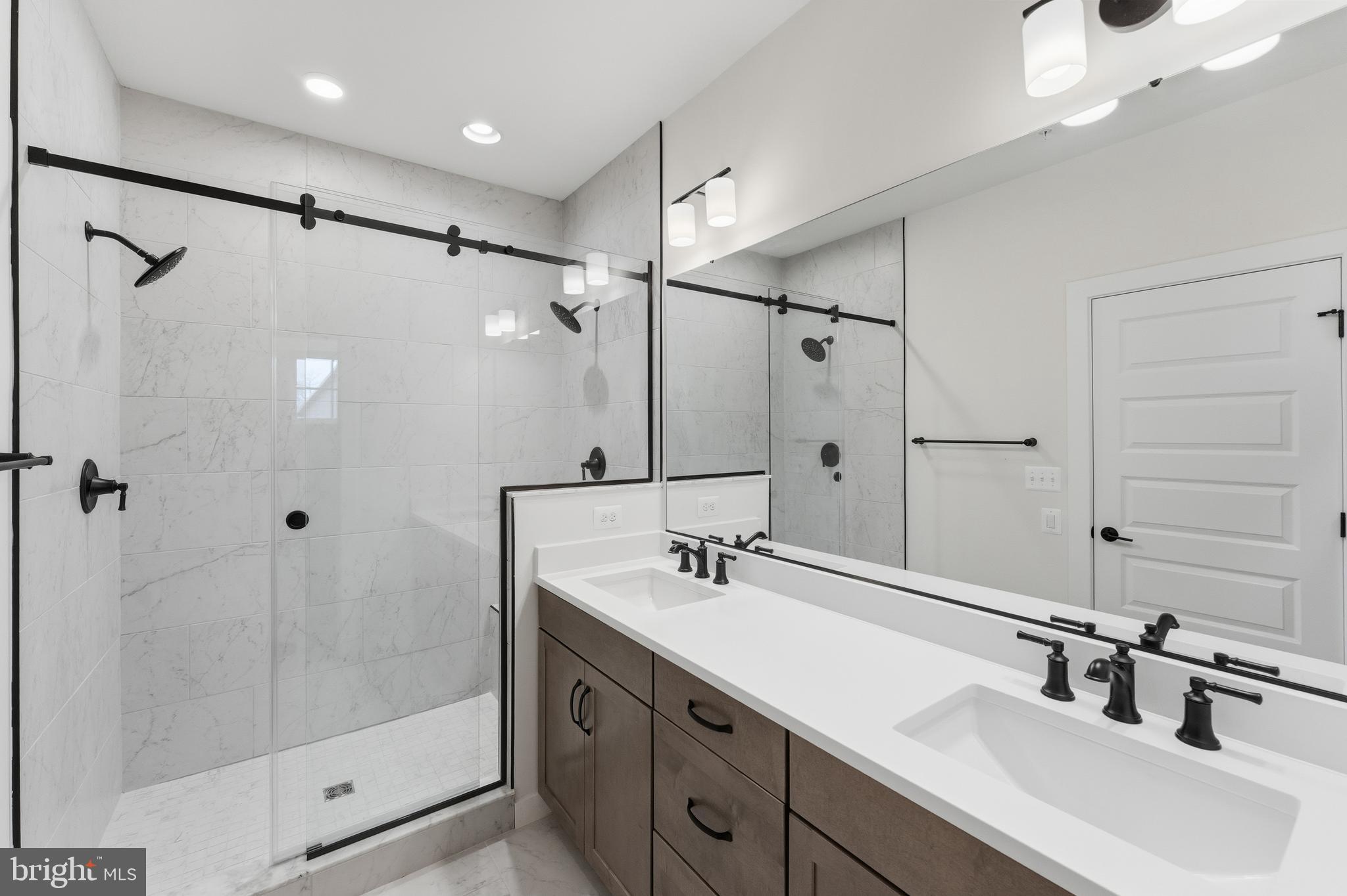 19110 Tatie Way Poolesville, MD 20837 - Photo 17 of 29 a bathroom with a double vanity sink a shower and a mirror
