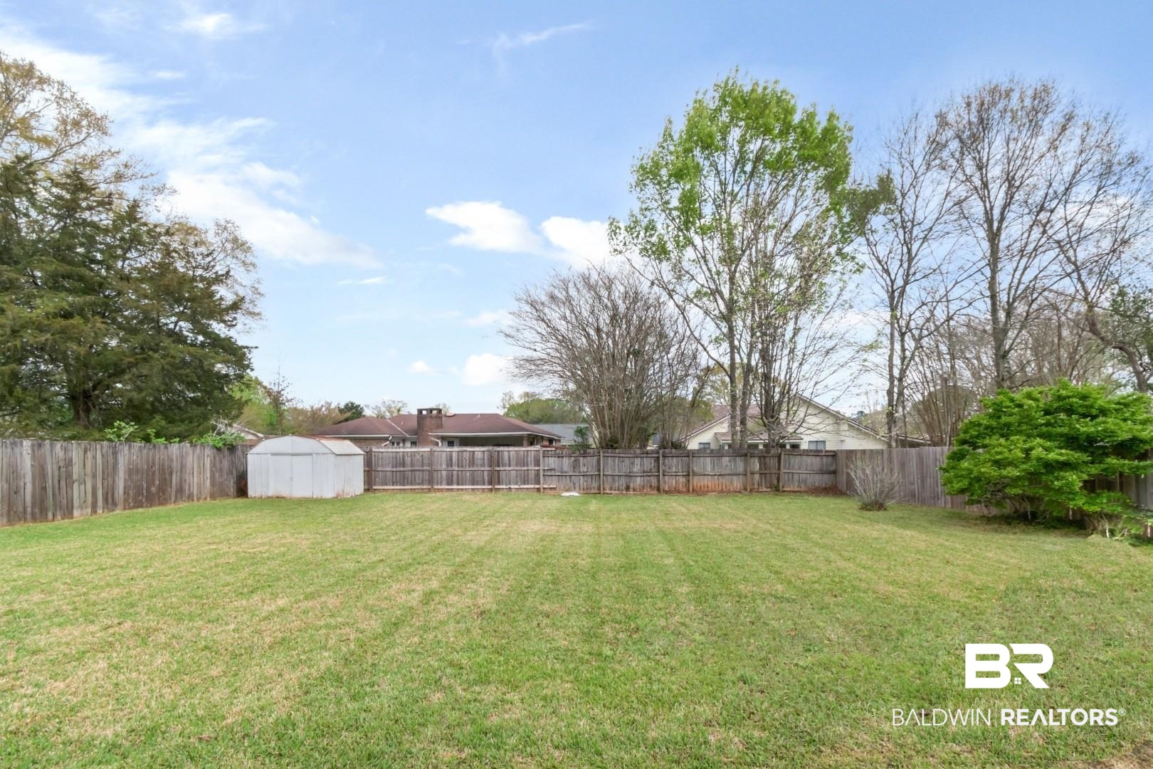 6208 Cottage Hill Road Mobile, AL 36609 - Photo 19 of 20 Fenced backyard with a storage unit
