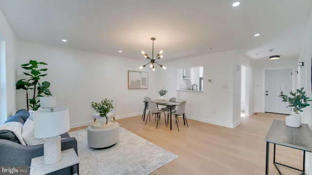 a view of a dining room with furniture and a chandelier
