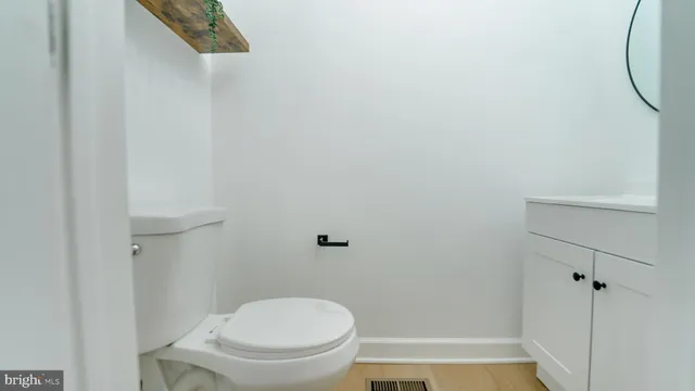 a bathroom with a granite countertop toilet and a shower