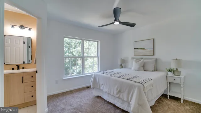 a bedroom with a large bed and a window